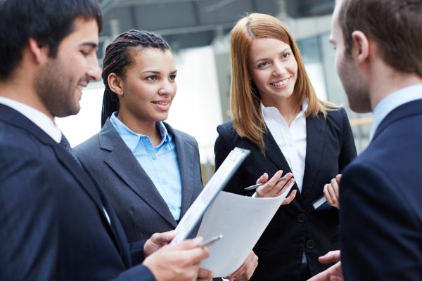 Group of business partners looking at their colleague during negotiations